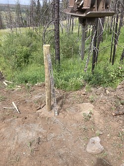 4-5”x7’ treated fence post being driven 36”